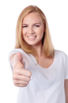 Smiling woman giving a thumbs up gesture