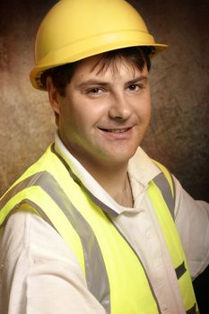 Confident builder in work clothes smiling