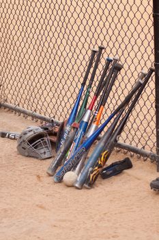 Baseball bats and fence.