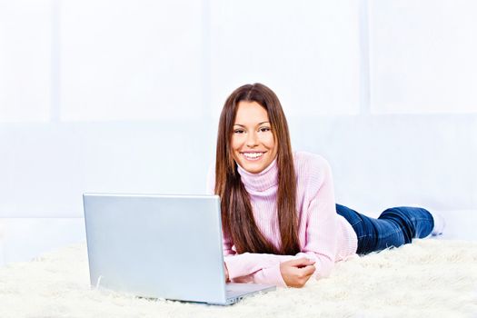 woman with laptop on carpet