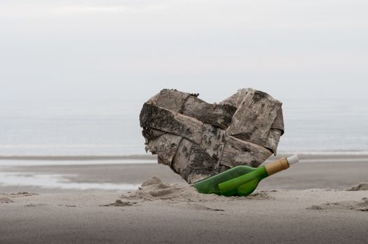 wooden heart and green bottle