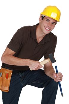 Man hitting chisel with hammer