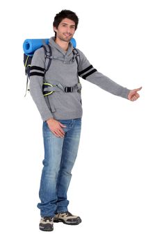 Man with backpack hitchhiking