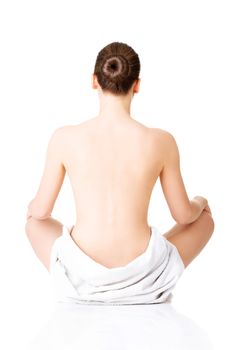 Young beautiful nude woman with towel practicing yoga , isolated on white