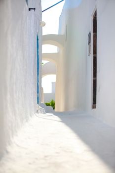 Traditional white deserted street at small town in the Greek Cyclades
