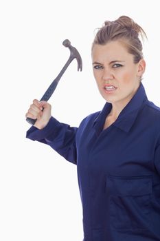 An angry female mechanic holding claw hammer