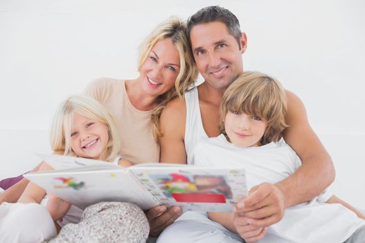Happy family reading a fairy tale together 