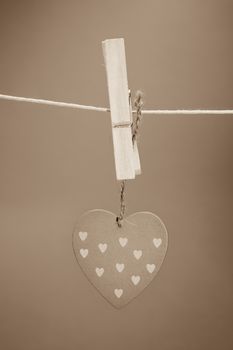 Heart ornament hanging from a peg on a line