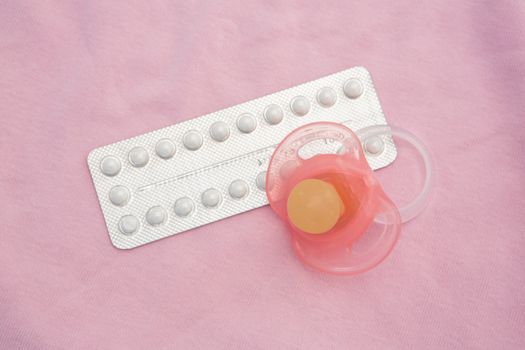 Contraceptive pill packet with pink soother