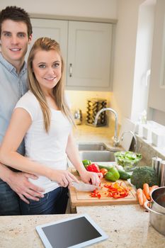 Man and woman cutting vegetables