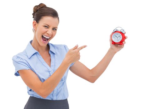 Businesswoman indicating alarm clock