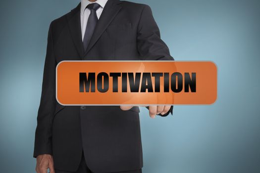 Businessman touching the word motivation