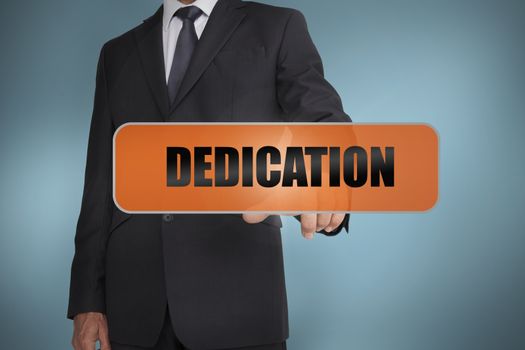 Businessman touching the word dedication 