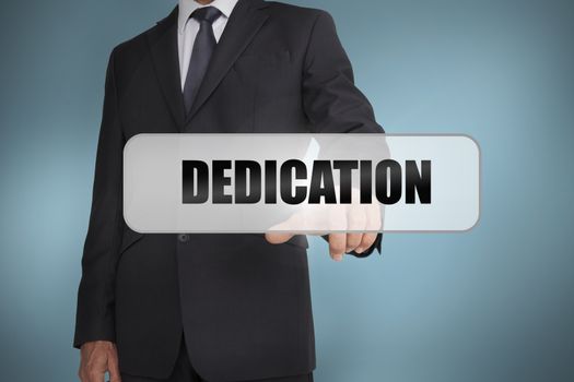Businessman selecting the word dedication written on white tag