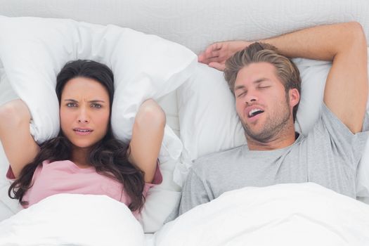 Woman annoyed by the snoring of her husband