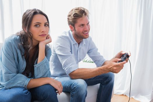Upset woman annoyed that her partner is playing video games