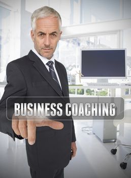 Businessman touching the term business coaching