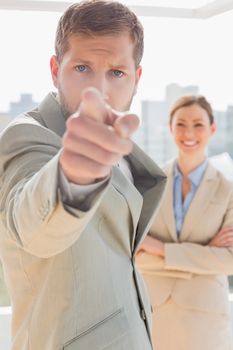 Annoyed businessman pointing at camera