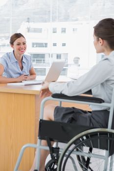 Businesswoman interviewing disabled job candidate