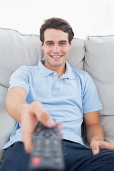 Portrait of a cheerful man changing channel