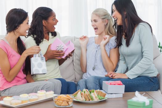 Friends offering gifts to woman during party