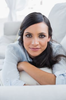 Peaceful dark hair woman lying on the couch