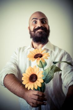 long beard and mustache man giving flowers