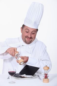 Chef seasoning the bill