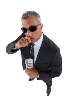 A crook holding stolen money and smoking a cigar