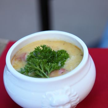 Bowl of hot soup garnished with parsley