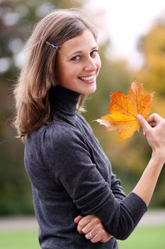 beautiful woman with a bouquet of maple leaves