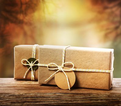 Handcrafted gift boxes with an autumn background