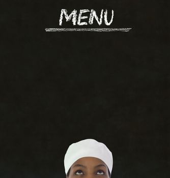 Chef with chalk menu sign on a blackboard background