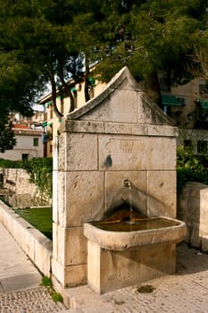 Old water fountain in the street of Chinchon, Madrid, Spain