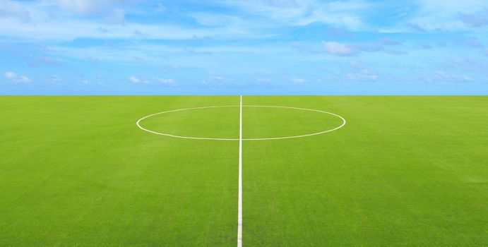 Center line on soccer field with blue sky