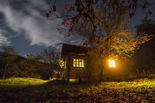 cottage in a mystical landscape at night