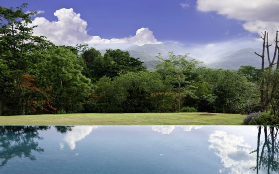 Cloud reflections on the infinity pool with beautiful landscape