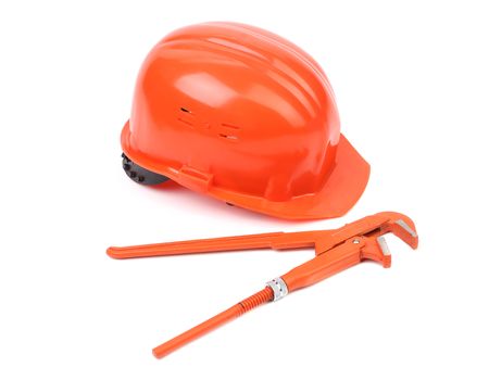 Hard hat and wrench close up.