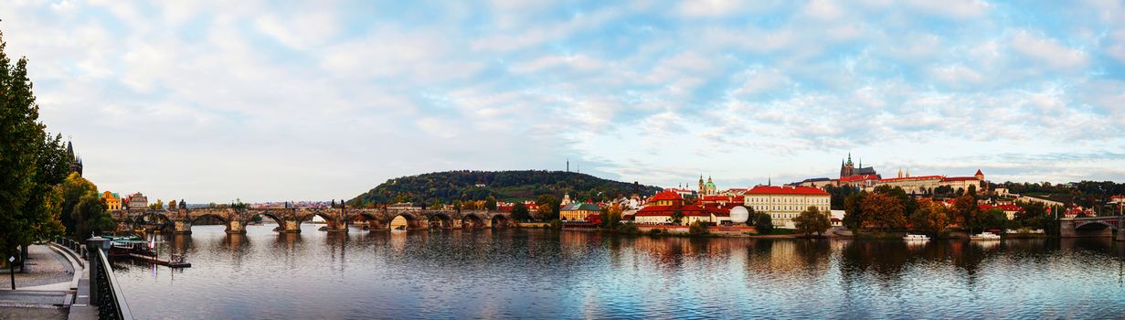 Panoramic overview of old Prague with Charles bridge in the evening