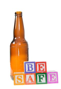 Letter blocks spelling be safe with a beer bottle