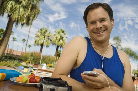 Man Listening to MP3 Player outdoors portrait.
