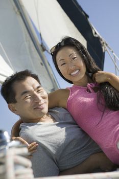 Couple embracing on sailboat (portrait)