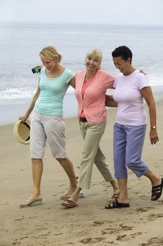 Three women walking on beach