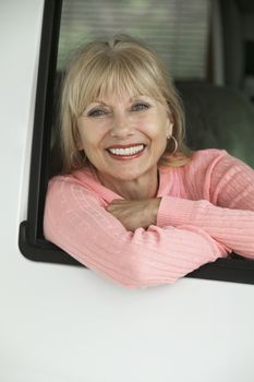 Woman smiling in vehicle (portrait)