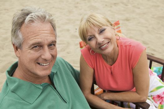 Closeup portrait of a smiling middle aged couple at the beach