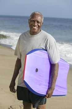Senior man holding surfboard