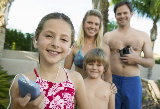 Girl Listening to MP3 Player Standing with Family