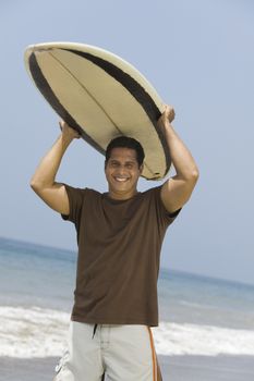 Man Carrying Surfboard Over His Head