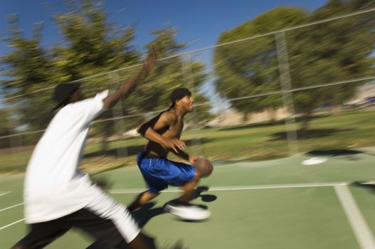 Young African American men playing basketball