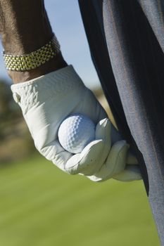 Close-up of a man's hand holding golf ball